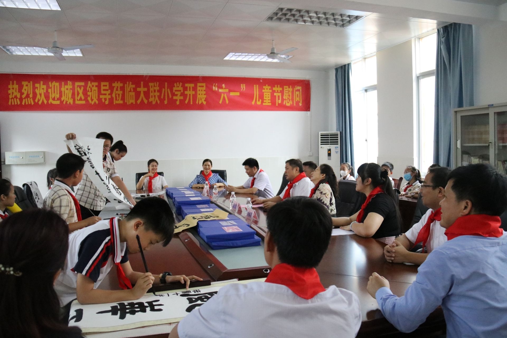 覃良川一行观看大联小学少年队代表书法表演.